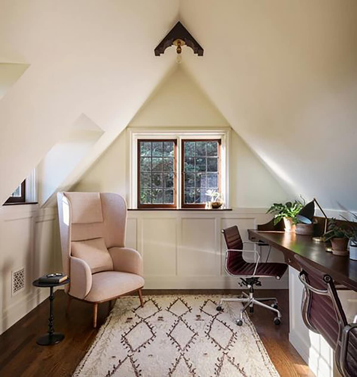 geometric shaped rug in a slanted room