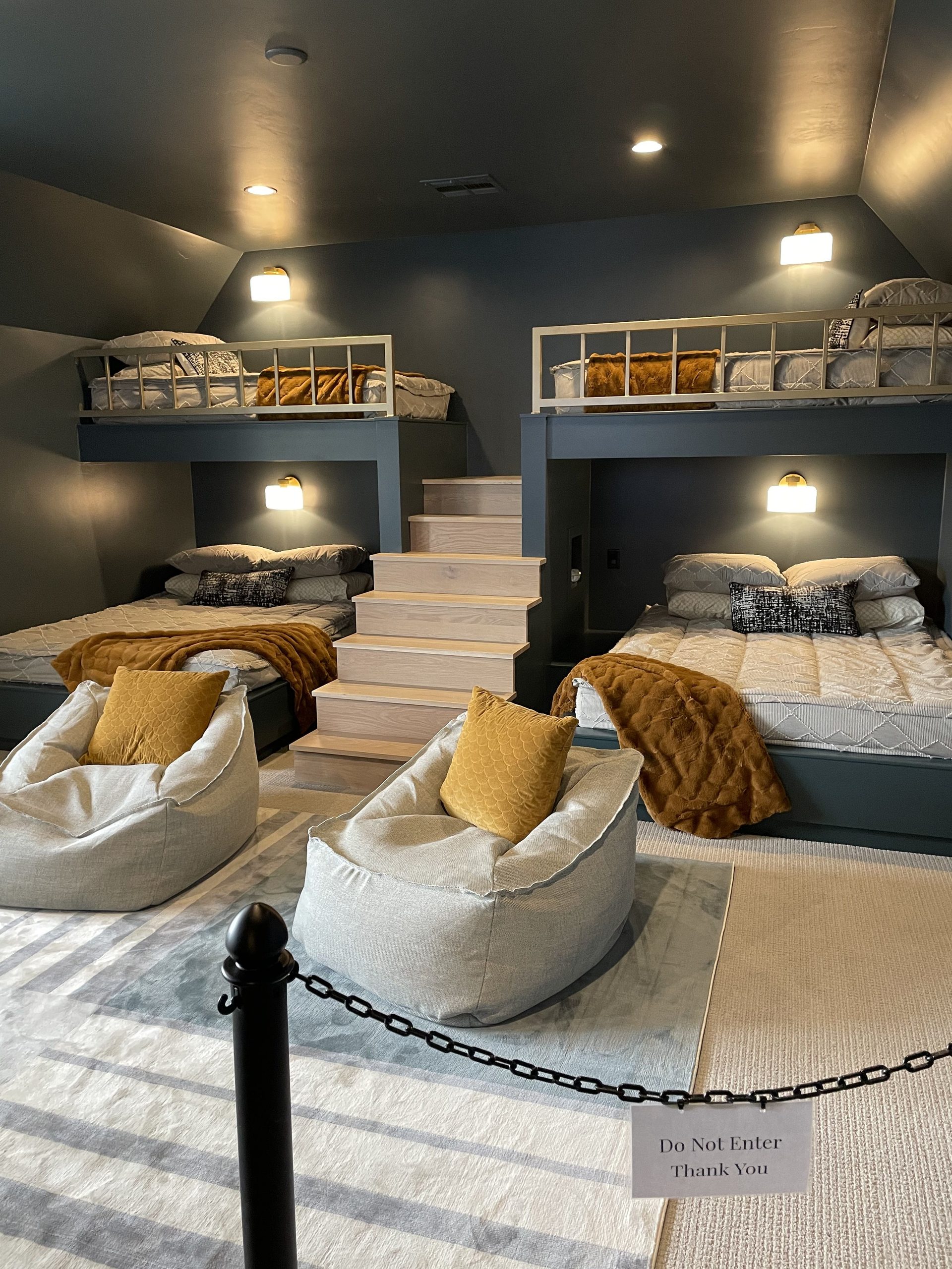 bold bedroom design with with aesthetic bunk beds and poufs