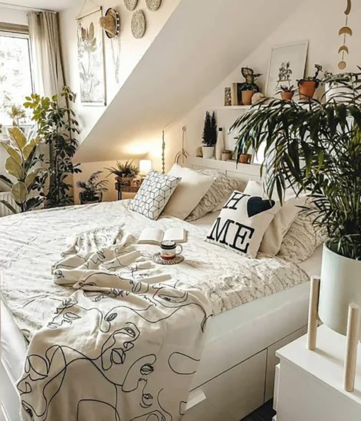 boho bedroom with plants and slanted walls