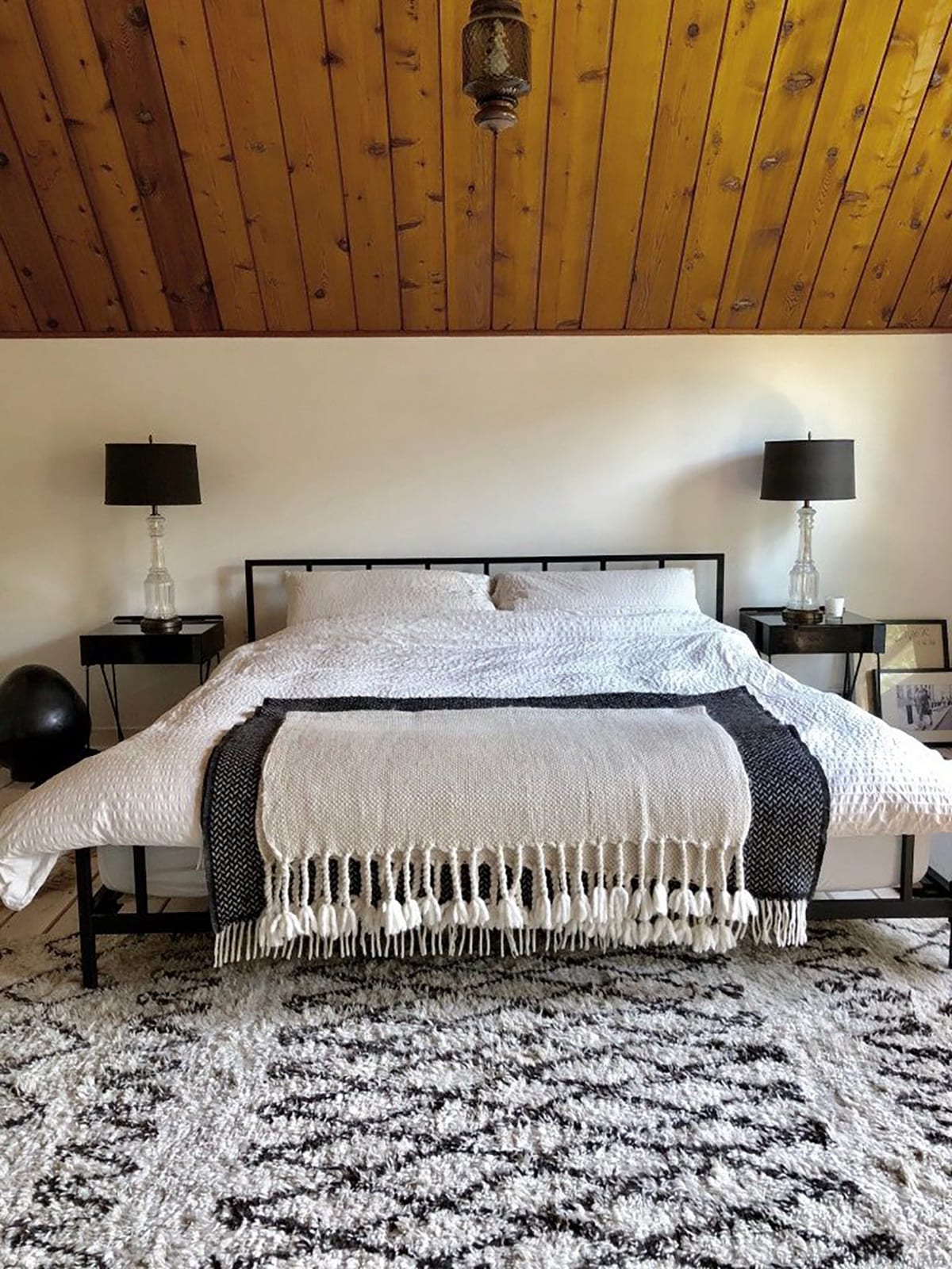 walnut slanted wall bedroom contrasted by a white wall