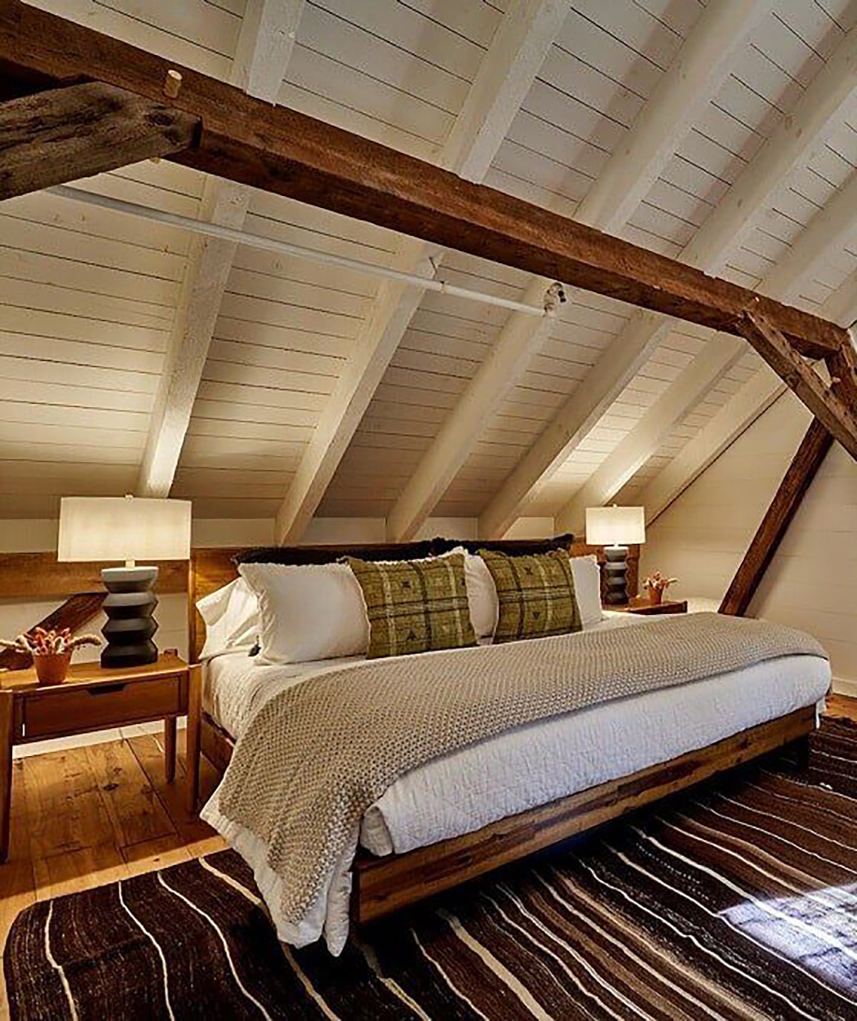 wood beams over a slanted wall bedroom