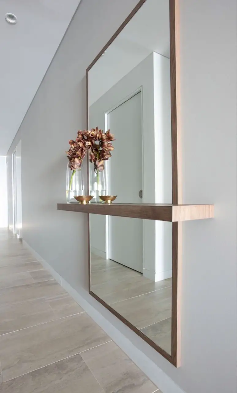 Install a Mirrored Panel over the Door to Hide it