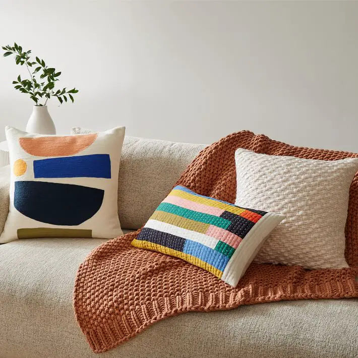 Style Beige Couch or Sofa with a Throw Blanket