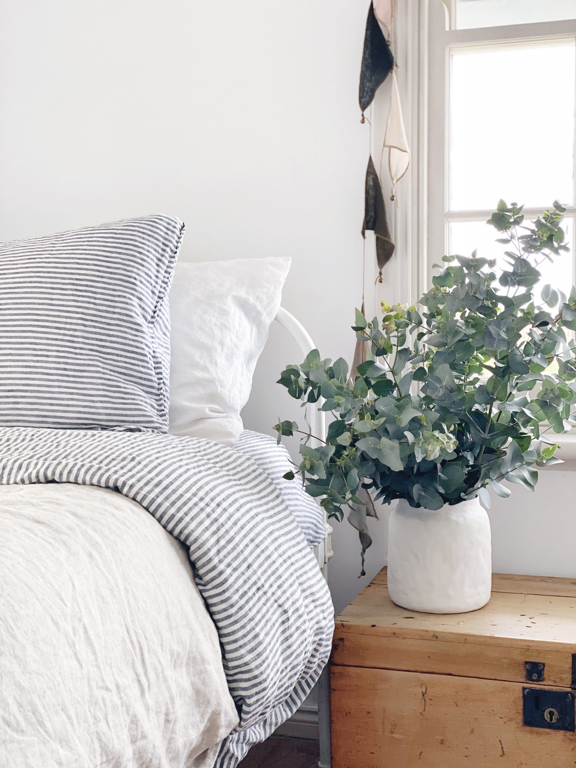 Use some plants instead of the second nightstand to create a natural look.