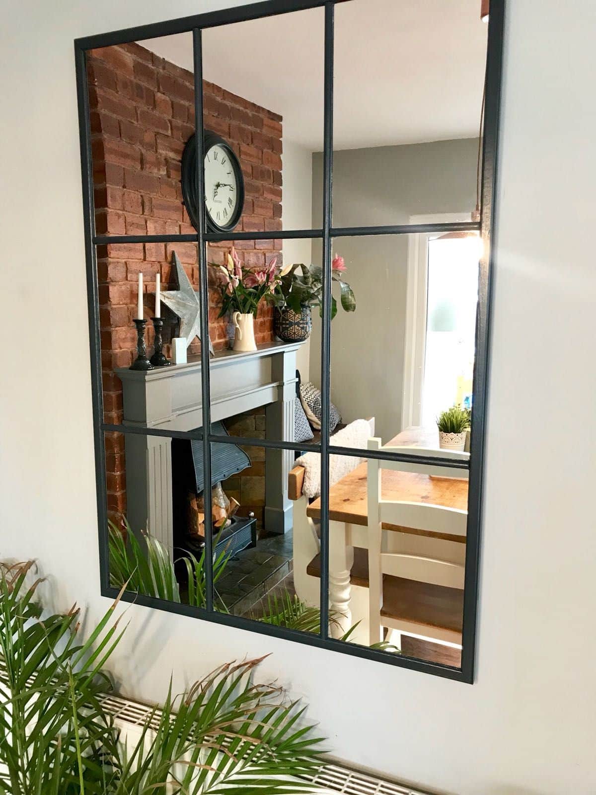 Consider placing a mirror on the opposite wall to reflect light and make the room feel brighter and more open.