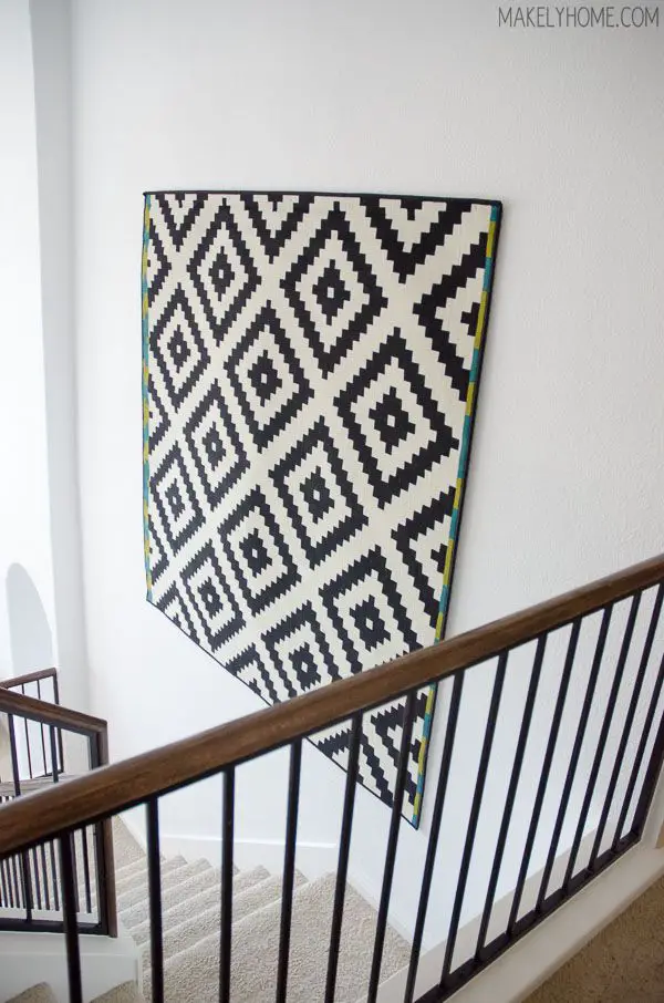 Hang tapestries or other fabric accents to soften the look of a two-story wall and add texture and color.