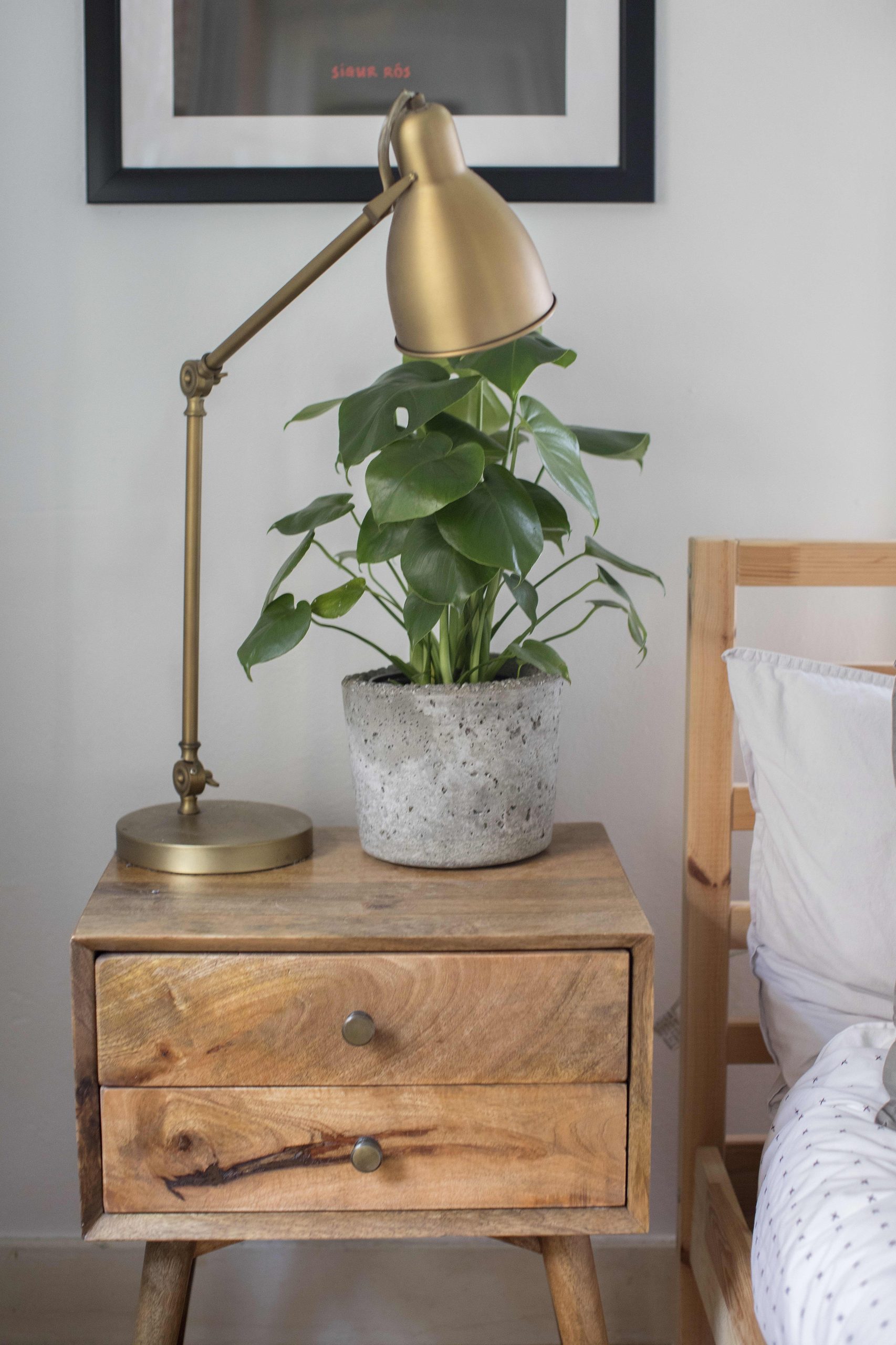 If you have two beds in the bedroom, try placing the nightstand in between them at the foot of the bed.