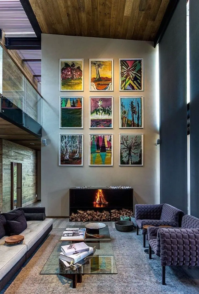 Don’t be afraid to use large pieces of furniture or bold statement pieces on a two-story wall. It can handle it!