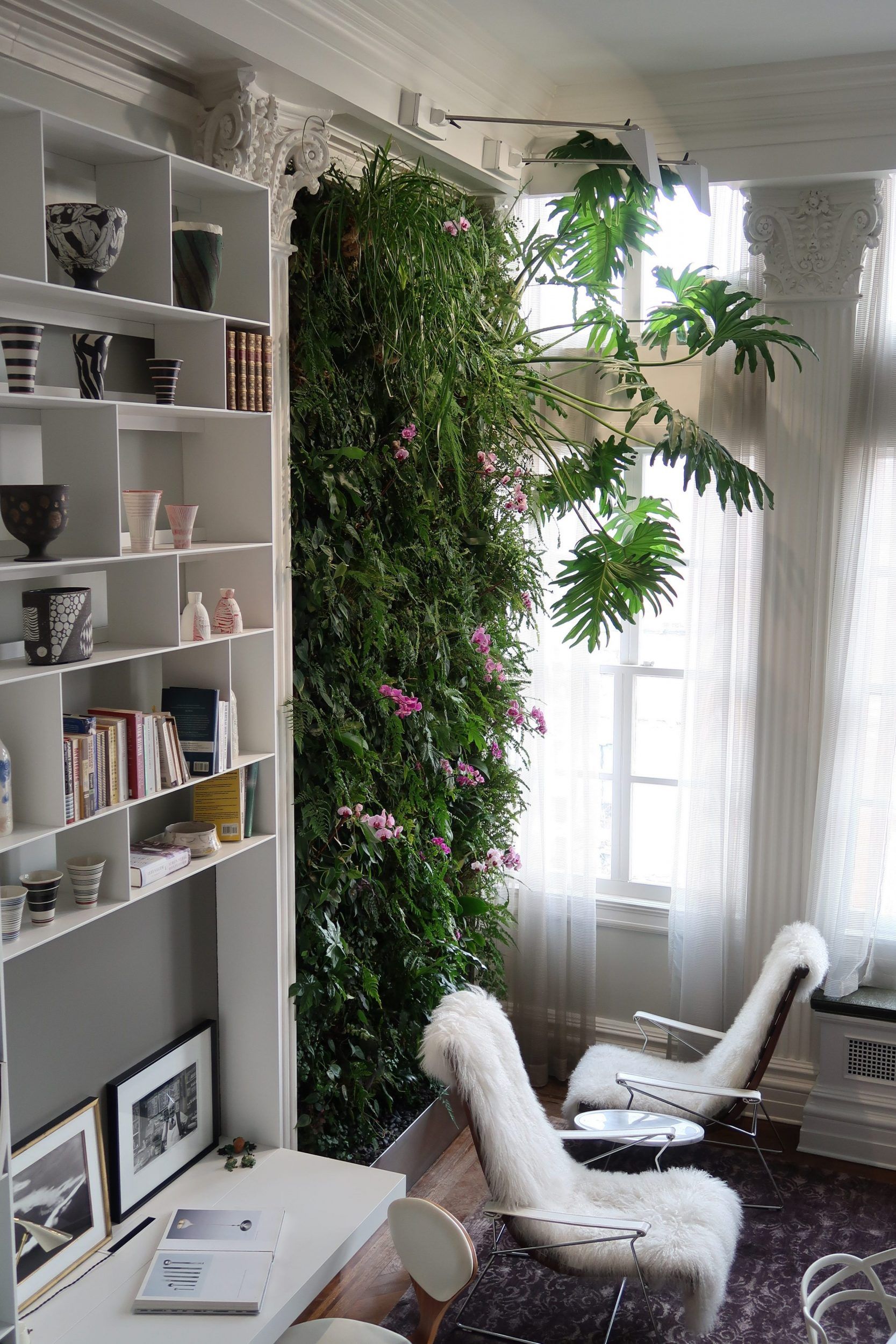 Intersperse plants throughout your two-story wall for a touch of natural beauty.