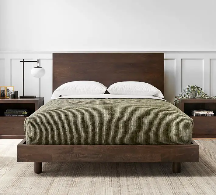 Green creates an earthy, natural feel that’s perfect for a bedroom retreat with dark wood furniture.