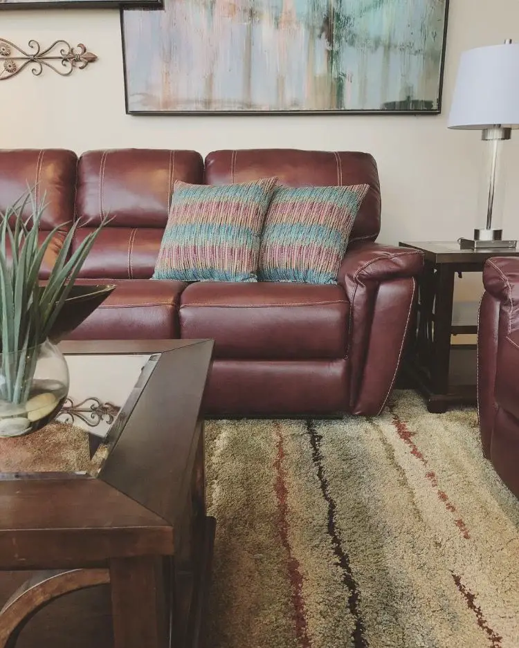 Try adding a white or cream-colored coffee table to bring some lightness into the room. This will help draw attention to…