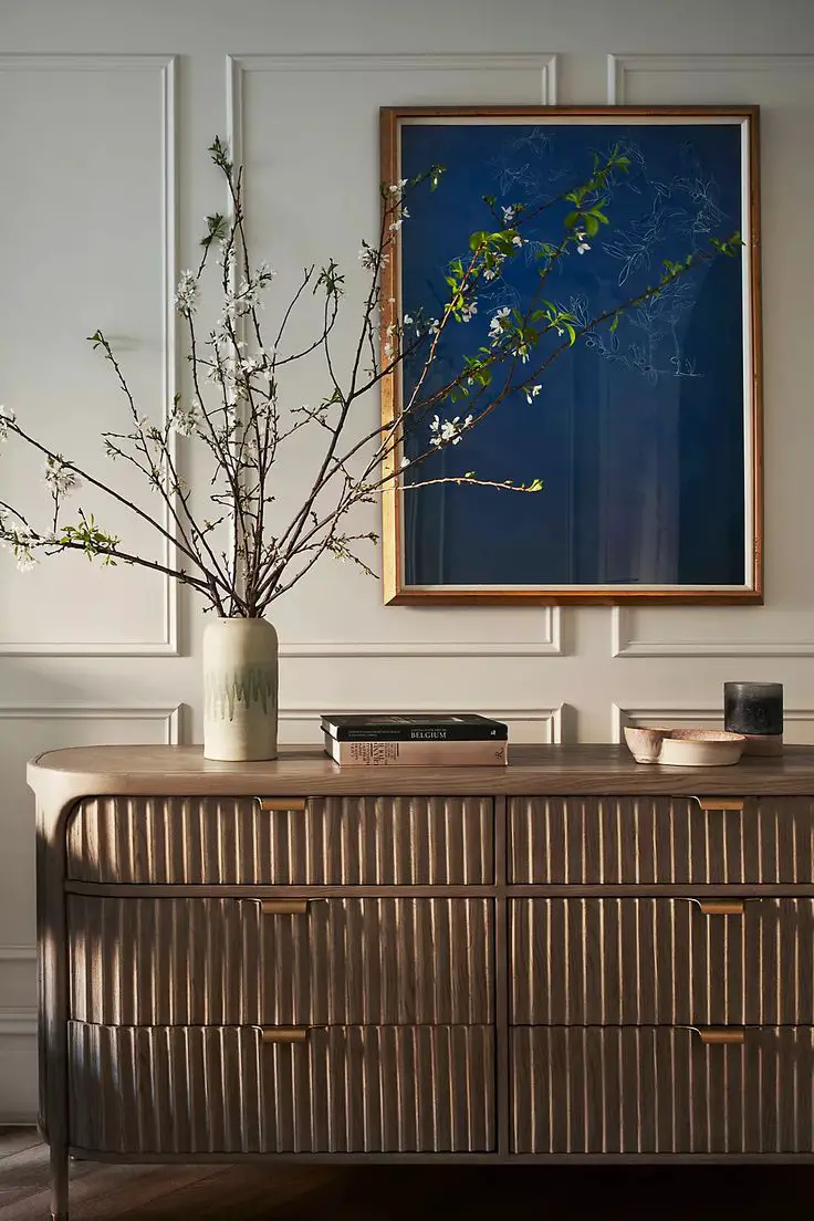 Create an interesting focal point by placing a small houseplant on the top shelf of your console. This will be especially…