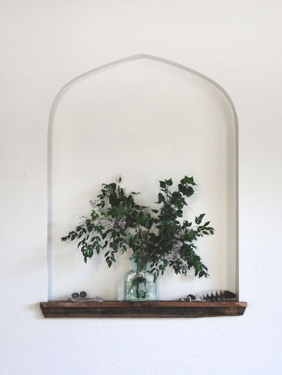 Add plants or flowers to bring some life and color to the niche.