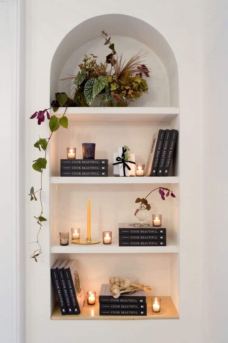 Place candles or vases of flowers on a shelf to add a warm and cozy ambiance.