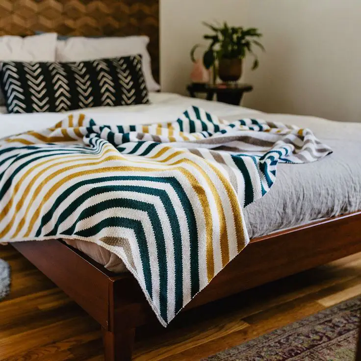 Finally, go the extra mile and layer two throw blankets with different colors or patterns for a truly eye-catching look.