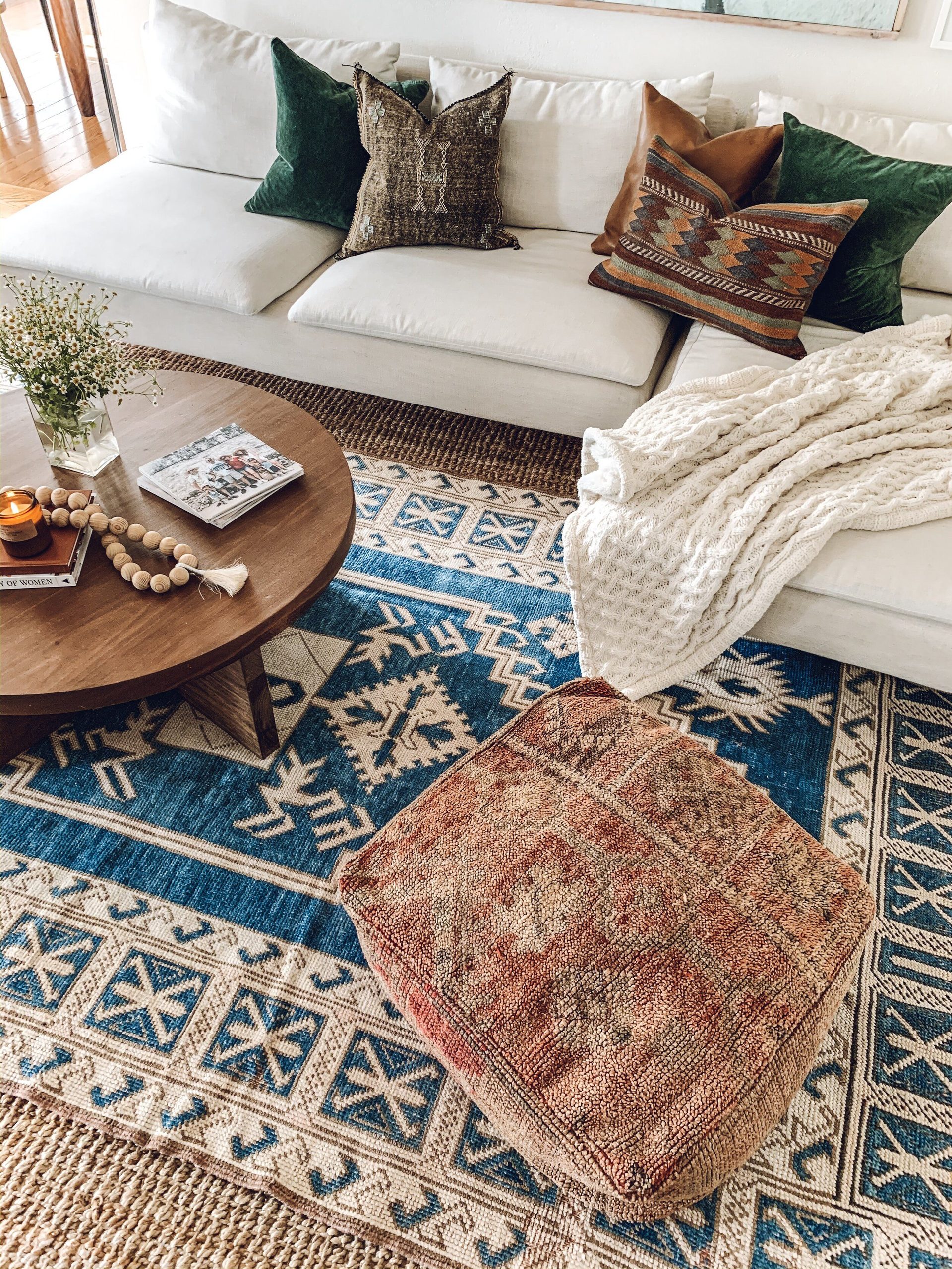 Make sure the sizes of your two rugs are different so that the patterned one stands out.