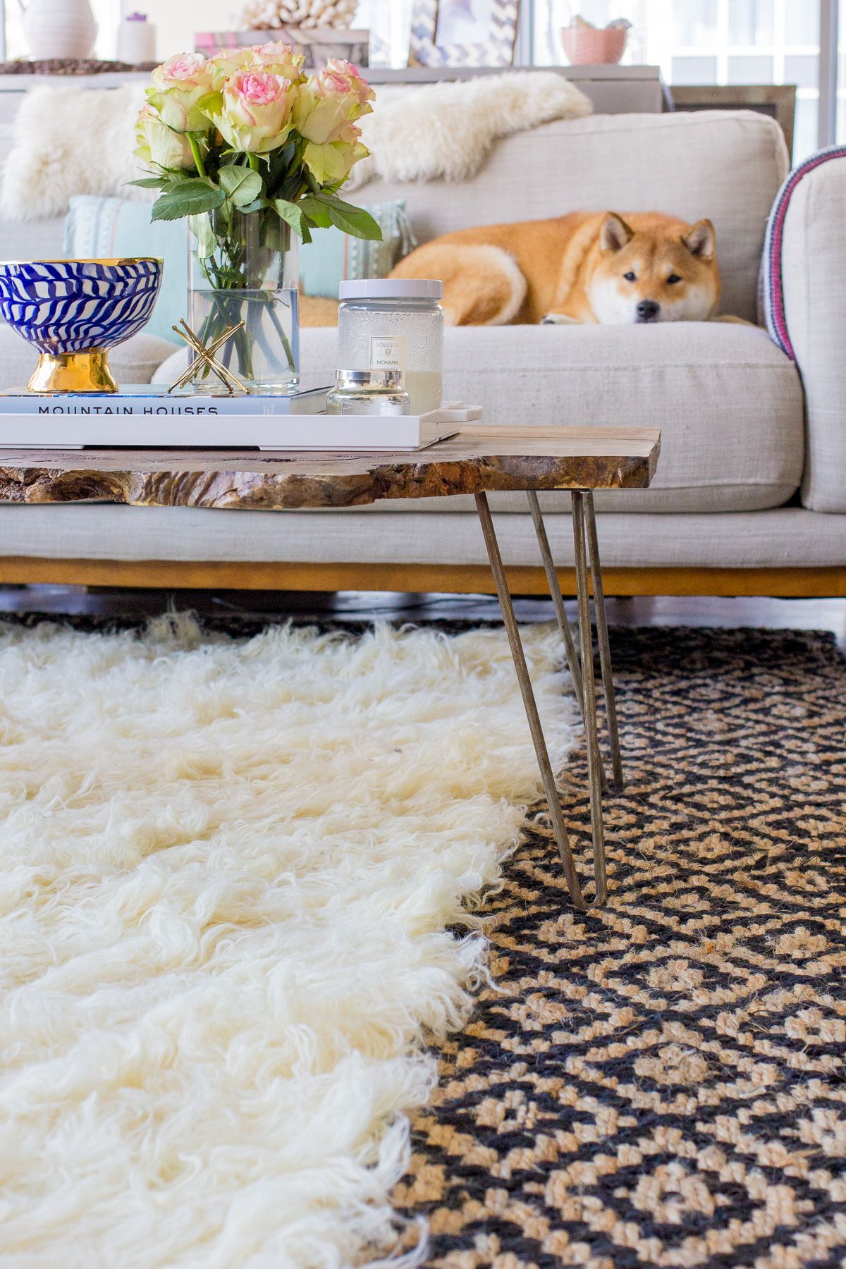 Select the smaller rug for the top layer – this one will be more decorative in nature and should stand out from the base…