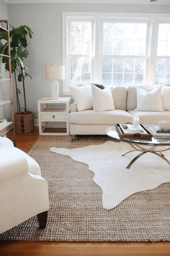 Start by selecting the larger rug – this will usually be the base layer and should be neutral in color and texture to…