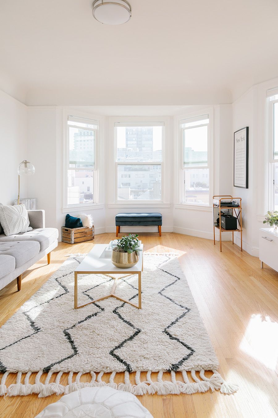 Light-Filled Living Room with White Paint and Light Parquet Floors