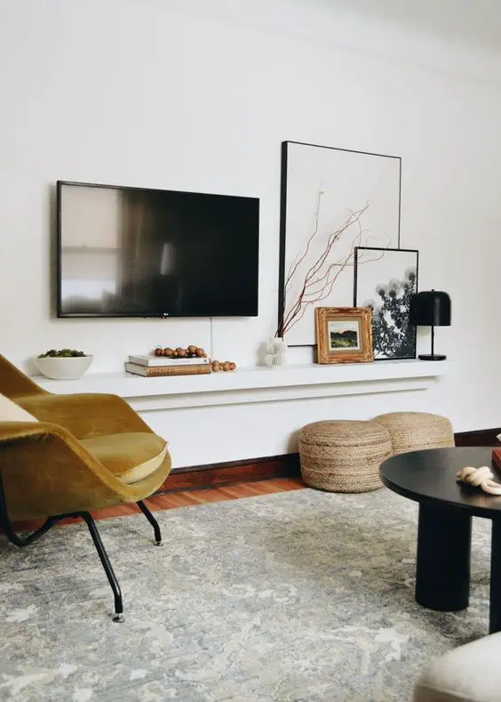 How can I manage cable clutter when installing a wall-mounted TV for a sleek and clean look?