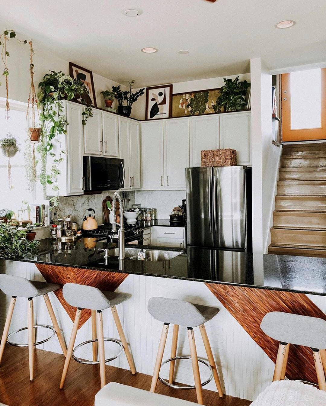 How do I choose the right color scheme for the decor above my kitchen cabinets?