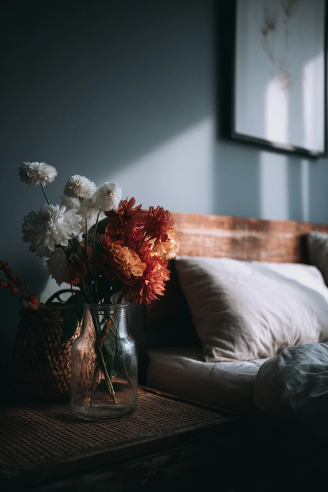 Bedroom with a wooden headboard that has built-in shelves behind the bed