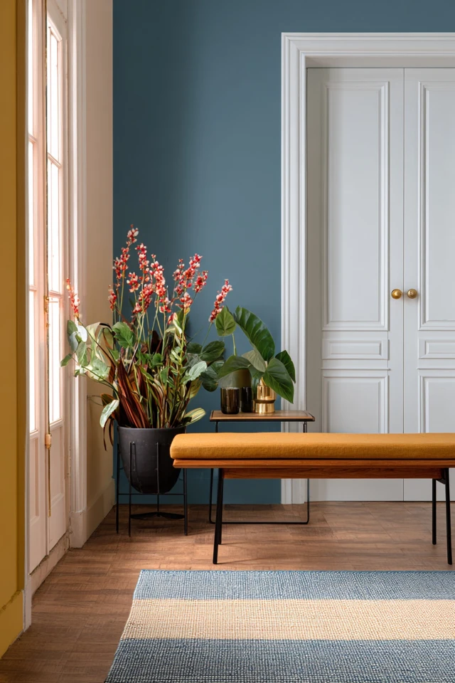 Entryway wall decor and furniture arranged in a warm foyer