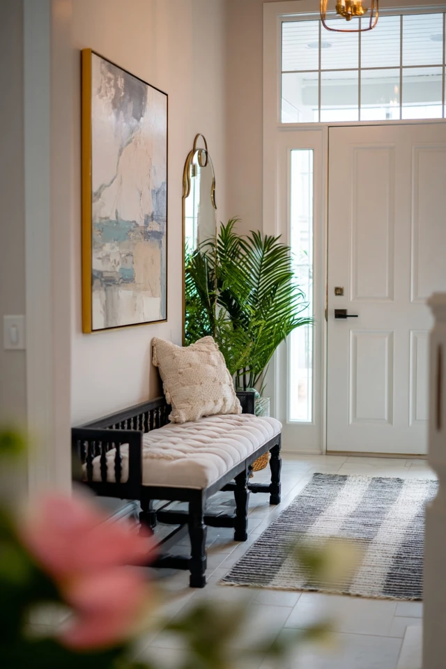 Entryway mirror arrangement with console and decor near the front door