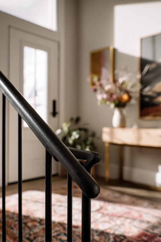 Spacious foyer with furniture and lighting arranged to guide you inside